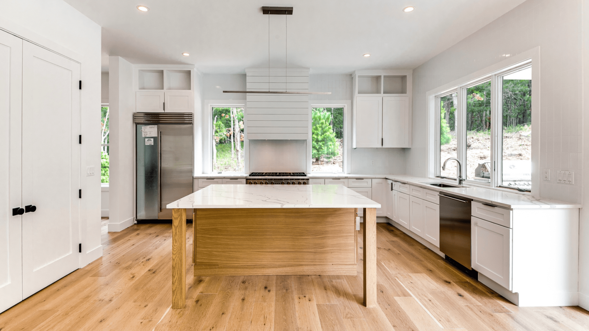 Modern East Hampton home at 49 Cosdrew Lane featuring clean lines, lush greenery, and sleek architectural design